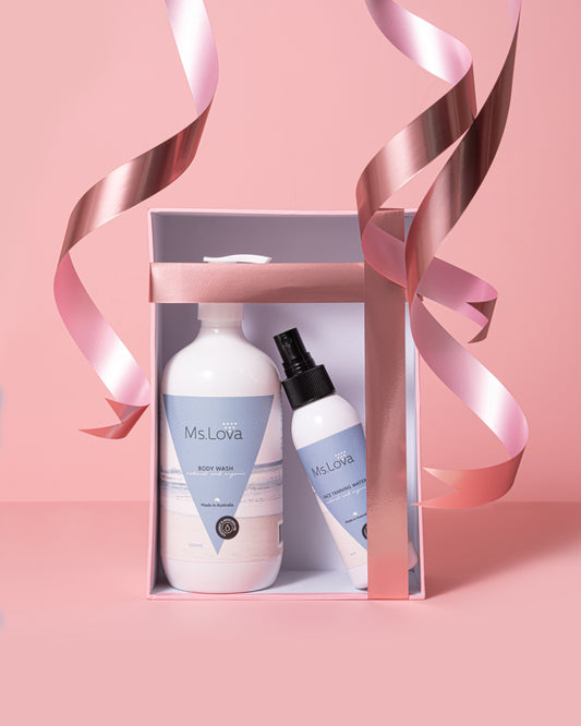 Ms. Lova self tanning gift set with Face Tan Water and Body Balm in pink ribbon packaging for a natural glowing tan.
