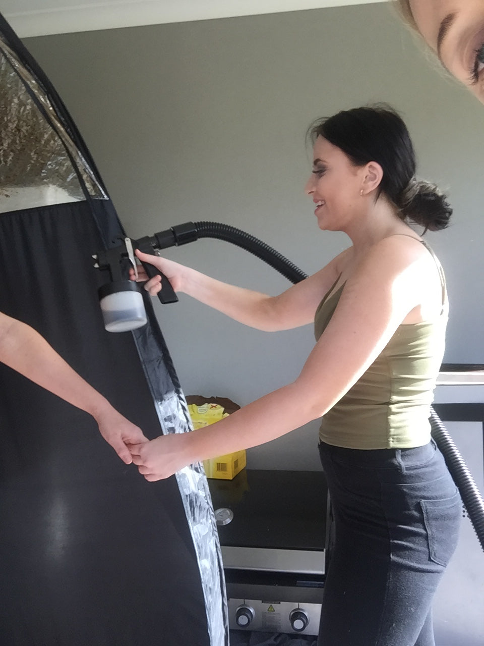 Student learning hands-on spray tan application during Ms.Lova private spray tan training workshop in Sydney.
